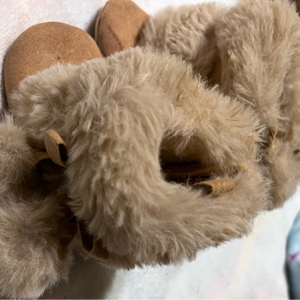 Furry brown boots with with boba balls on the side the great for a baby 0-3 mo